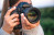 young-woman-with-professional-camera-takes-photo-nature